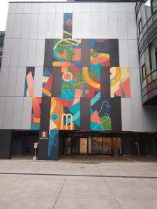 a building with a mural on the side of it at Comfy Condo Near Downtown in Kitchener