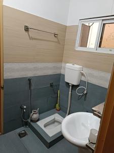 a bathroom with a toilet and a sink at Islamabad Comfort Home in Islamabad