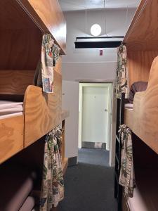 a room with two bunk beds and a doorway at Fox Glacier Jade Hotel in Fox Glacier