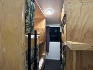 an interior view of a tiny house with a staircase at Fox Glacier Jade Hotel in Fox Glacier