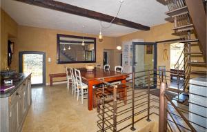 a kitchen and dining room with a wooden table and chairs at Awesome Home In Ville-Di-Paraso in Ville-di-Paraso