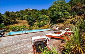 a swimming pool with lounge chairs and a mountain at Awesome Home In Ville-Di-Paraso in Ville-di-Paraso +14 photos