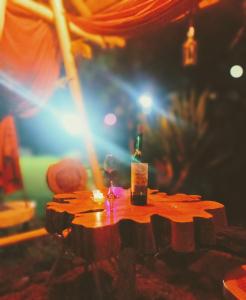 a bottle of wine sitting on top of a table at Cabaña en La Calera con Jacuzzi in La Calera