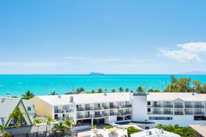 an aerial view of a building with the ocean in the background at OCEAN VIEWS 16 pool & Spa Wi-FI in Airlie Beach
