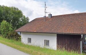 a white building with a brown roof next to a road at Holiday Home Wiesenfelden - 08 in Wiesenfelden +15 photos