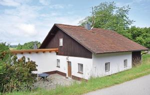 a small white building with a brown roof at Holiday Home Wiesenfelden - 08 in Wiesenfelden
