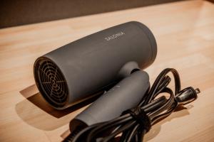 a cord plugged into a device on a wooden table at Solabase in Kazo