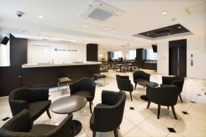 a waiting room with chairs and tables and a podium at Sunrise Inn Iwaki in Iwaki