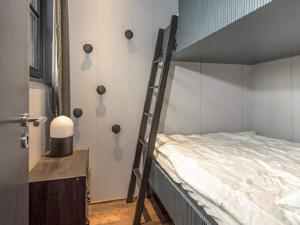 a bedroom with a bunk bed with a ladder at Holiday home SÄLEN II in Stöten