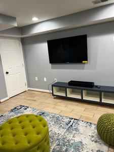 a living room with a flat screen tv on a wall at Chic Downtown In-Law Suite in Washington, D.C.