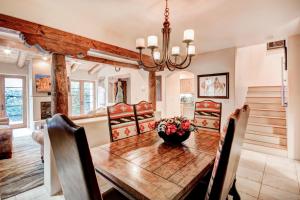 a dining room with a wooden table and chairs at El Corazon de Santa Fe, 3 Bedrooms, Sleeps 6, Flat Panel TVs, Fireplaces in Santa Fe