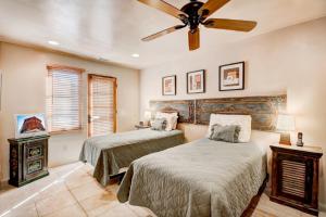 a bedroom with two beds and a ceiling fan at El Corazon de Santa Fe, 3 Bedrooms, Sleeps 6, Flat Panel TVs, Fireplaces in Santa Fe