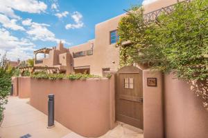 a house with a wooden door and a fence at El Corazon de Santa Fe, 3 Bedrooms, Sleeps 6, Flat Panel TVs, Fireplaces in Santa Fe