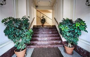 a staircase with two potted plants on the side of a building at 1 Bedroom Lovely Apartment In Recco in Recco +9 photos