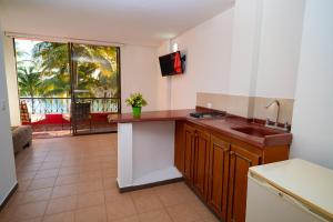 a kitchen with a sink and a large window at Playa Hawai Ibague in Ibagué