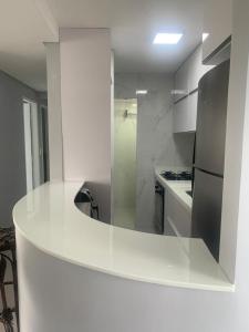 a kitchen with a white counter and a refrigerator at Apt na Torre - Recife in Recife