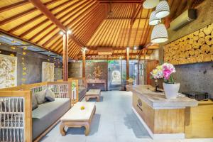 a living room with a couch and a table at Seminyak Sanctuary Villa by Ini Vie Hospitality in Legian