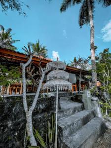 a resort with stairs leading up to a building at Mertha Sari Resto & Bungalow in Klungkung