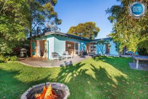 a house with a fire pit in the yard at Beachwood - Firepit - Pet Friendly - 2 Mins Walk to the Beach in Callala Beach