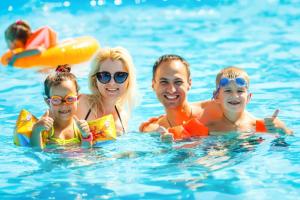 a family in the water at a swimming pool at Lovely 6 Berth Caravan With Decking At Sunnydale Holiday Park Ref 35130sd in Louth