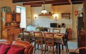 a kitchen with a table and chairs and a kitchen with a table and a table at 4 Bedroom Lovely Home In Le Cloitre S Thegonnec in Le Cloître-Saint-Thégonnec