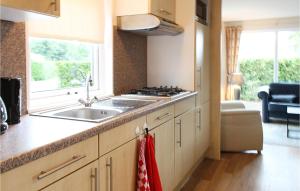 a kitchen with a sink and a stove at Stunning Home In Tzummarum With Kitchen in Tzummarum