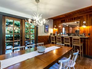 a kitchen and dining room with a wooden table and chairs at Pendleton Pines Lodge in Glacier