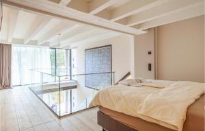 a bedroom with a bed and a glass staircase at Prora Solitaire Avida Loft 9 in Binz
