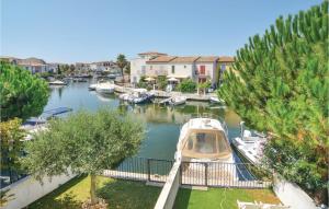 a boat is docked in a marina with houses at Nice Home In Aigues-mortes With Kitchen in Aigues-Mortes