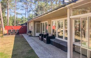 a screened in porch of a house with couches at 4 Bedroom Gorgeous Home In Yngsj in Åhus
