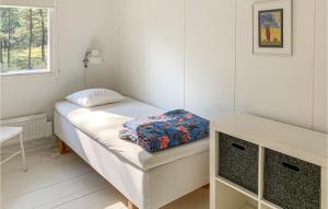 a small white room with a bed and a window at 4 Bedroom Gorgeous Home In Yngsj in Åhus