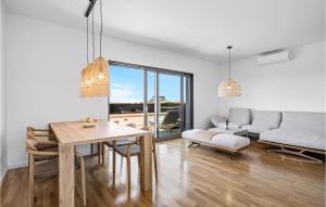 a living room with a table and a couch at 3 Bedroom Amazing Apartment In Vodice in Vodice