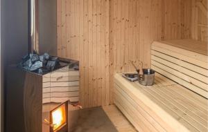 a sauna with a heater and a fire in it at Nice Home In Långserud With Sauna in Rullan