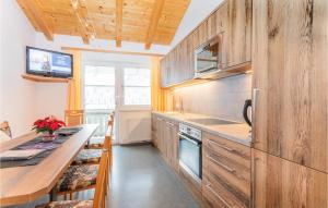 a kitchen with wooden cabinets and a counter top at Beautiful Apartment In Viehhofen With 4 Bedrooms And Internet in Viehhofen