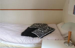 a small bed with two pillows on top of it at 3 Bedroom Stunning Home In Blomsterdalen in Blomsterdalen