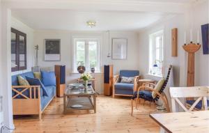 a living room with a blue couch and a table at 3 Bedroom Stunning Home In Blomsterdalen in Blomsterdalen