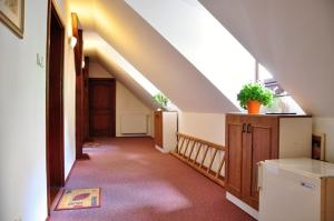 an attic room with a staircase and a stair case at Penzion Podhradí in Český Krumlov