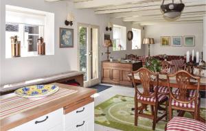 a kitchen and living room with a table and chairs at Lindersgrden in Staffanstorp