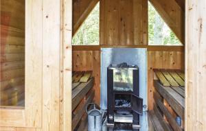 an inside view of a wooden cabin with a wood stove at Lindersgrden in Staffanstorp