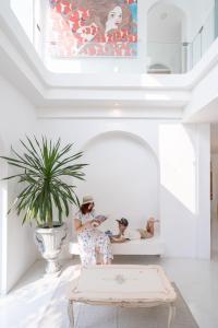a woman sitting on a bench in a living room at Arpo Pool Villa Riverside Bangkok in Bangkok +45 photos