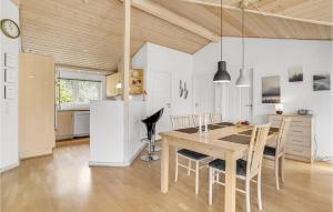 a kitchen and dining room with a table and chairs at Nice Home In Fårvang With Sauna in Fårvang