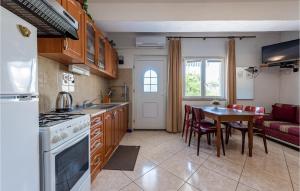 a kitchen and dining room with a table and a couch at Stunning Apartment In Pag With Wifi in Pag