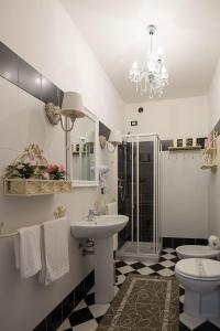 a bathroom with a sink and a toilet and a mirror at Il Casale Relais in San Giuliano Terme