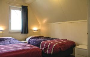 a bedroom with two beds and a window at Awesome Home In Gramsbergen With Wifi in Gramsbergen +18 photos