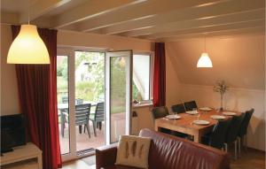 a dining room with a table and a balcony at Awesome Home In Gramsbergen With Wifi in Gramsbergen