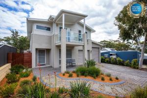 a house in the suburbs of sydney at Havenwood - Pet Friendly - Spa & Community Pool in Callala Beach