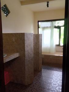 a bathroom with a sink and a window at Family Guest House in Ubud