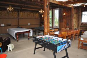 a room with a pool table and ping pong tables at Kauri Villas in Parua Bay