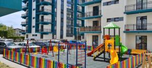 a playground in front of a apartment building at Brizza Apartments 5 Mamaia Nord in Mamaia Nord