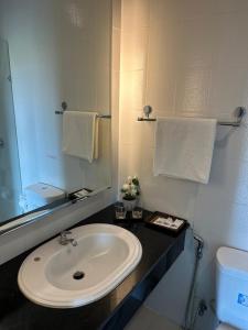 a bathroom with a sink and a mirror at Kata Sea Blue in Kata Beach